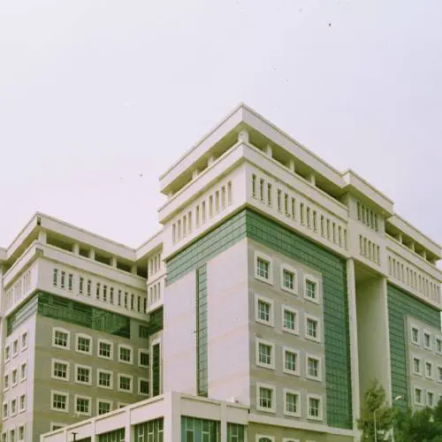 Modern multi-story building with green accents.