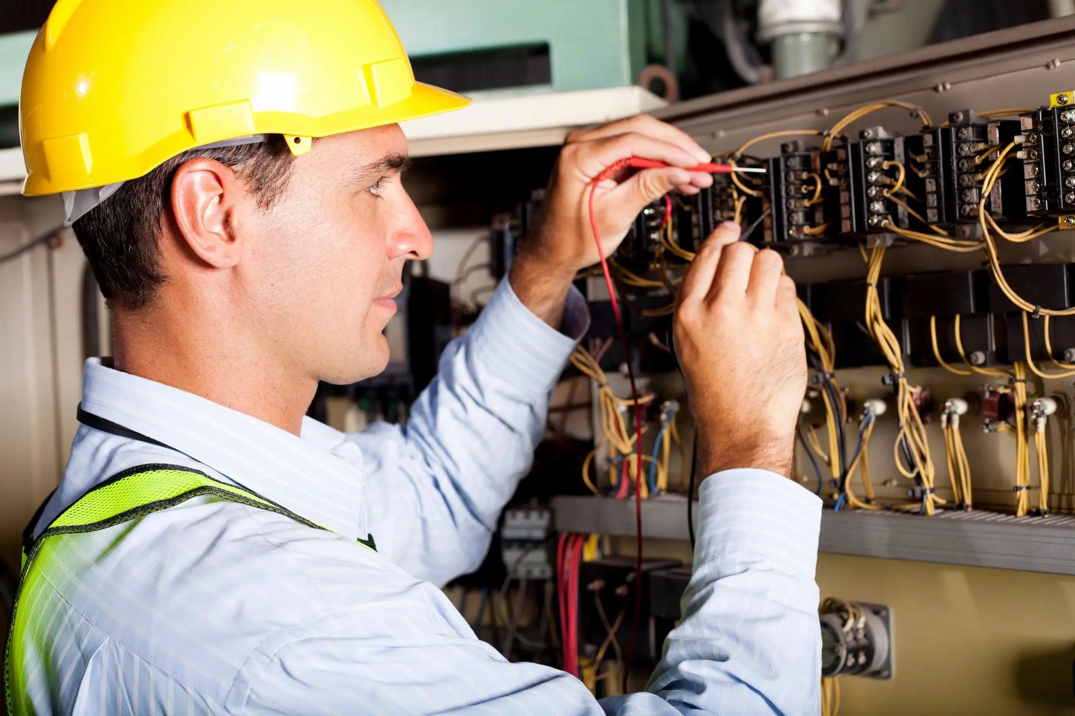 Electrician working on electrical panel wiring.