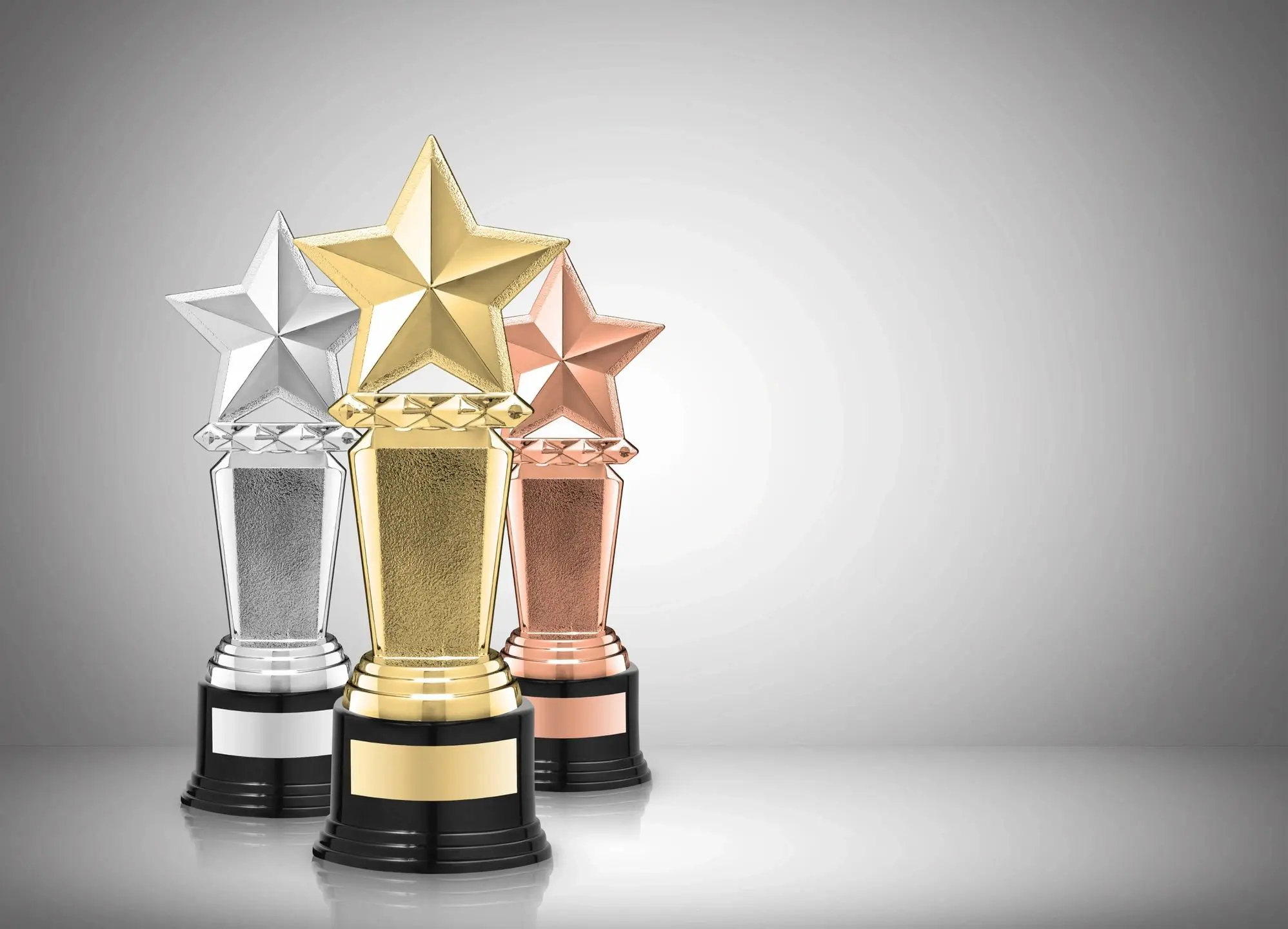 Gold, silver, bronze star-shaped trophies displayed.