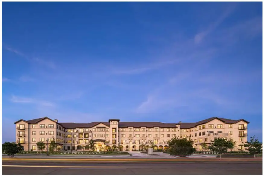 Large illuminated apartment building at dusk